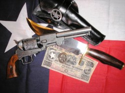 Texas Ranger display using 1849 Dragoon replica, Bowie knife, Mexican loop holster, badges and period currency against a Texas Republic flag background.